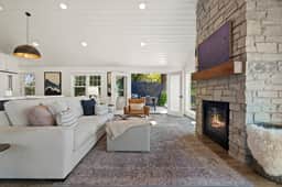Living room with features French doors which open to the patio overlooking the lake and garden