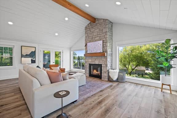Enjoy a large Pottery Barn coach and leather chair while enjoying the gas fire place of Smart TV.  Or  the lake view never gets old!