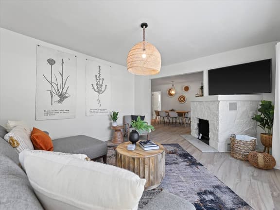 Bright beautiful living room with 65” TV with streaming services  
Fireplace is not functional